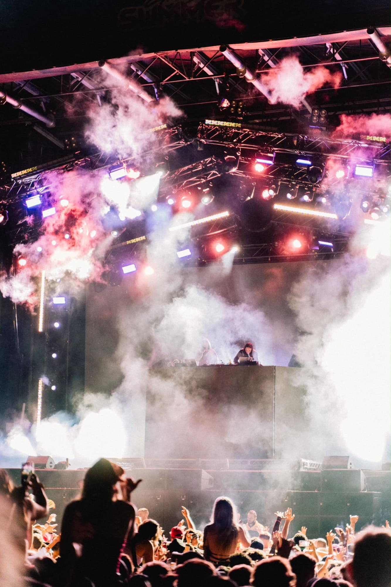 Main stage under smoke and lighting rig, crowd on the floor